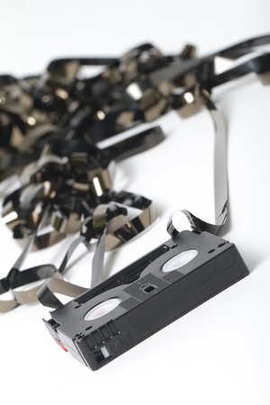 close-up shot of a broken mini dvc tape  focus on tape in foreground  shot on white backgroundの写真素材