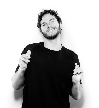 a young male adult showing his black t-shirt on white. black and white.
の写真素材