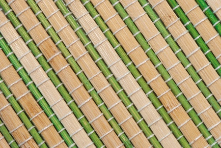 colored mat of bamboo tied with ropeの写真素材