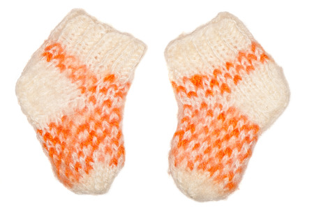 two fluffy knitted baby socks, isolate on white backgroundの写真素材