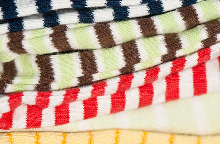 carelessly stacked striped fabric in different colorsの写真素材