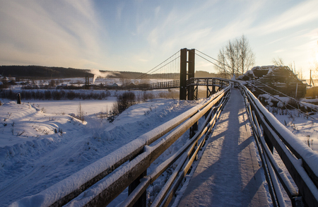 suspension bridge over the river in winter, Russia, Arkhangelsk region.の写真素材