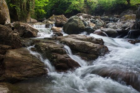 the mountain river flows among the stones. Spring, Georgia.の写真素材