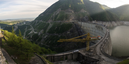 The Inguri hydroelectric power station at sunset is illuminated by the rays of the sun. panoramaの写真素材