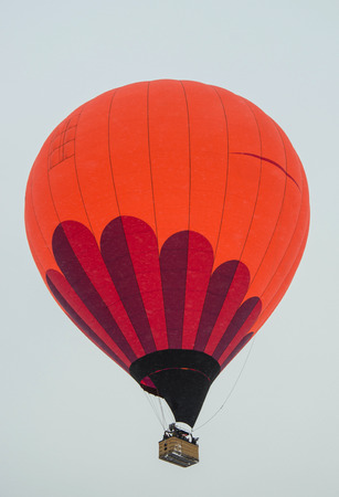 multicolored balloon flies on a bright sky backgroundの写真素材