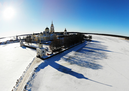 Nilov Hermitage. Surrounded by the frozen Lake Seliger. View of the monastery from the air. Russia, Tver region. Panoramic shot, shot from a drone.の写真素材