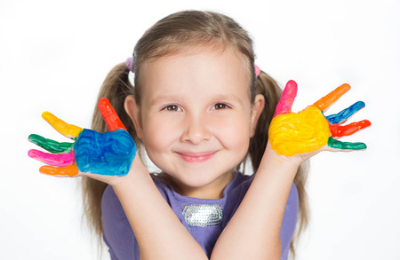 happy cute girl waving with coloured handsの写真素材
