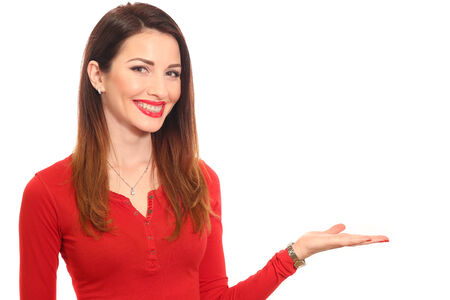 Attractive woman in red holding product with a hand isolatedの写真素材