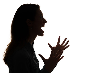 profile of screaming woman in silhouetteの写真素材