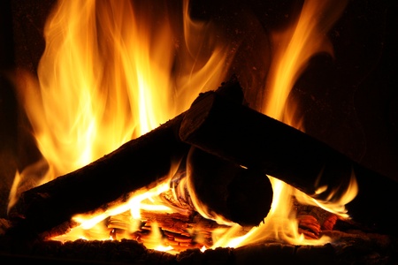 Fire in a fireplace, fire flames on a black backgroundの写真素材