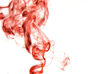 Red smoke isolated on white backgroundの写真素材