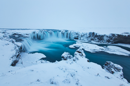 Beautiful Godafoss-Waterfall in Winter Covered in Snow, Icelandの写真素材