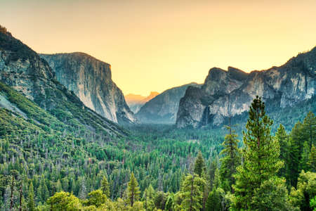 Illuminated Yosemite Valley view from the Tunnel Entrance to the Valley at Sunrise, Yosemite National Park, Californiaの写真素材