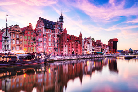 Illuminated Gdansk Old Town with Calm Motlawa River at Sunset, Poland, Europe