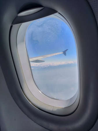 View from airplane window. Airplane wing through the porthole.の写真素材