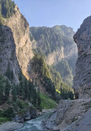 Mountain landscape with a river in the foreground. The mountain river flows through the gorge.の写真素材