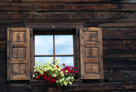 an old mountain house windowの写真素材