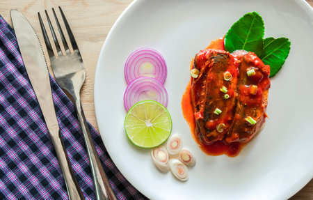 Canned fish with tomato sauce on wood background. top view or flat lay.の写真素材