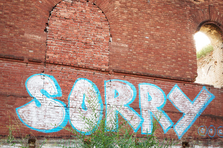 texture of wall from an old red brick with the inscription  "sorry"の写真素材