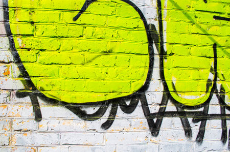 Brick wall with bright graffitiの写真素材