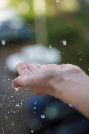 On the female the palm of the falling raindropsの写真素材