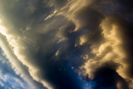 Dark sky before the storm. Clouds Illuminated by the sun.