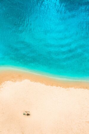 Aerial Top Drone view of a people couple on the Sand beach. Azure Beach River water and People. Vacation sea Background.の写真素材