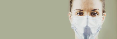 Banner Portrait of a Female Patients Doctor in a Protective Surgical Sterile Mask. Copyspase. Soft focus.の写真素材