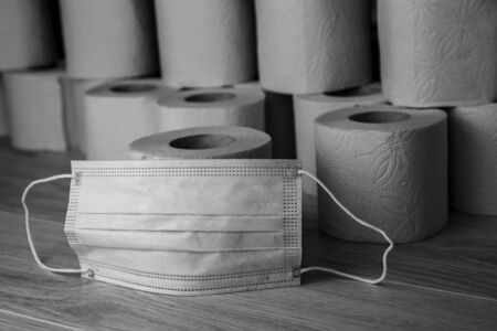 Black-and-white concept medical protective mask and toilet paper. Self-isolation items during the epidemic COVID-19.の写真素材