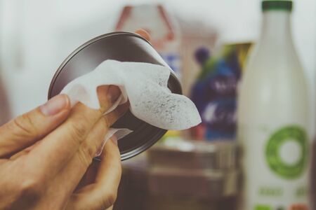 A woman washes groceries after buying them in the supermarket. Self-isolation and caution during the coronavirus pandemic.の写真素材