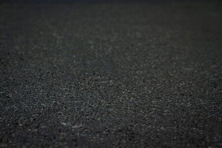 The surface of the black asphalt is a soft focus, an abstract background at an angle of 20 degreesの写真素材