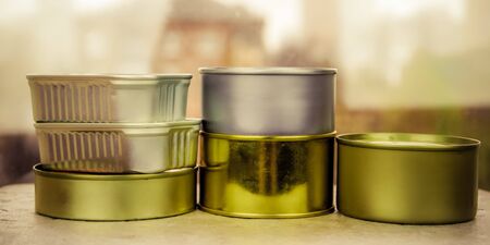Long-term food supply: stew, meat, fish in cans of various shapes, sizes and colors on the table. Army rations.の写真素材