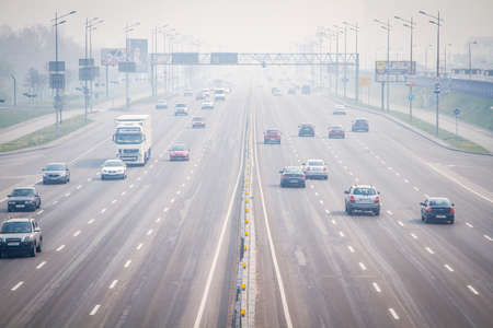 Smog, smoke and severe air pollution in Kiev. A view of Kyiv, Kiev city street filled with traffic next to a highway. Kyiv, Ukraine - 18 Apr 2020のeditorial素材