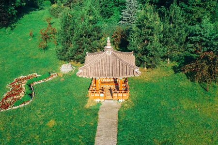 Korean house with a walkway in the garden among the trees. A bizarre rooftop house in the garden of South Korean culture. South Korean Pagoda.の写真素材