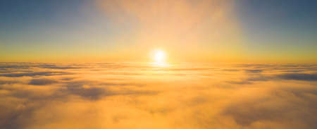 A picture of the rising sun above the fog at an altitude of 500 metersの写真素材