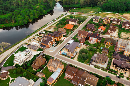 Construction of a cottage village on the river bank - aerial shotの写真素材