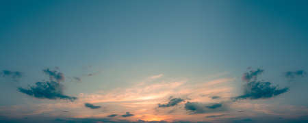 A panorama of the blue sunset sky with the sun. The sun went over the horizon in the blue sky.の写真素材