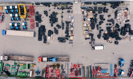 Lots of tires, spare parts, cultivators, planters and other agricultural machinery in the warehouse - overhead shotの写真素材