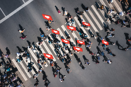 Crowd of people at pedestrian crossing with social heart icons and likes - overhead shotの写真素材