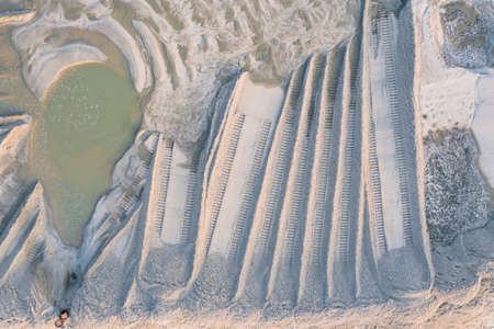 Traces of a bulldozer on the washed river sandの写真素材