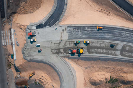 Road Construction of wide asphalt road with help of road transport equipment, top viewの写真素材