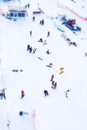 Skiers and snowboarders on a snowy slope in winter - vertical shotの写真素材