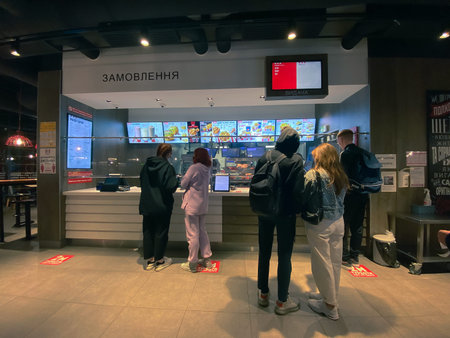 People buy food at a fast food restaurant in the evening