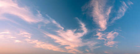 Rays of the setting sun break through the clouds - wide shotの写真素材