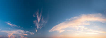Rays of the setting sun break through the clouds - wide shotの写真素材
