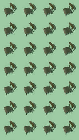 Green wooden chair, isolated on a green background with shade, vertical 16 x 9 shot.の写真素材