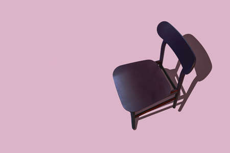 Brown wooden chair, isolated on a pink background with shade and copy spaceの写真素材