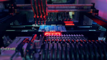 Pick and Place robot machine: SMD Assembly of electronic components on a motherboardの写真素材