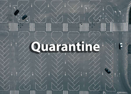 Empty car park with a lot of free places With QuarantineÂ textの写真素材