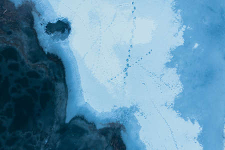 Texture of ice and snow on frozen winter river: top view drone shot.の写真素材